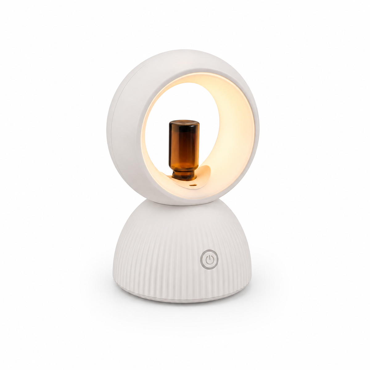 Halo diffuser with its warm light on and an amber essential oil bottle fitted in the ring