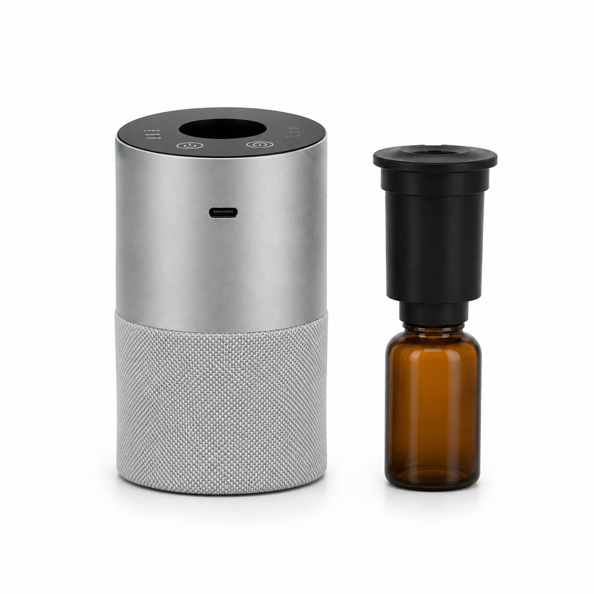 Nebula diffuser beside its nebulizer head fitted to an amber oil bottle